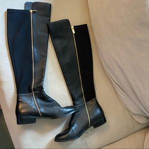 Knee-high black leather Michael Kors boots.
